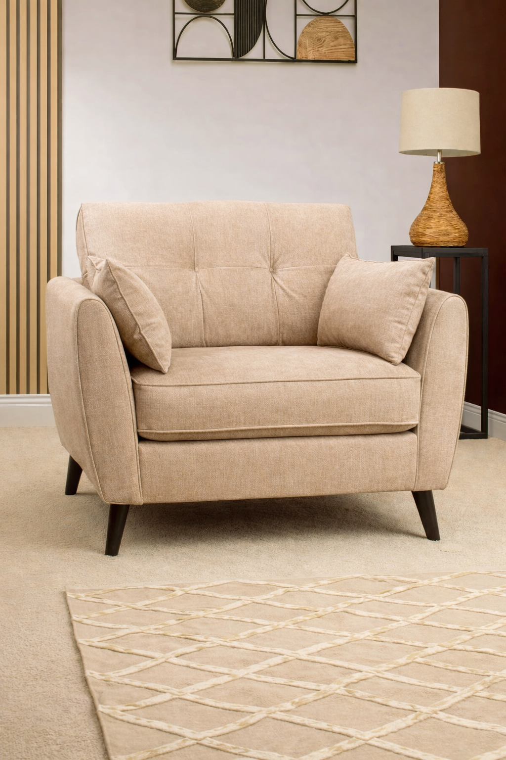 Beige armchair in a living room setting with a lamp and decorative wall art available at Sofa Emporium Retford