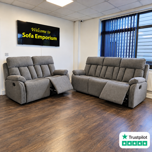 Grey fabric 3-seater and 2-seater reclining sofa set with padded armrests, high backs and extended footrests, displayed in the Sofa Emporium showroom.