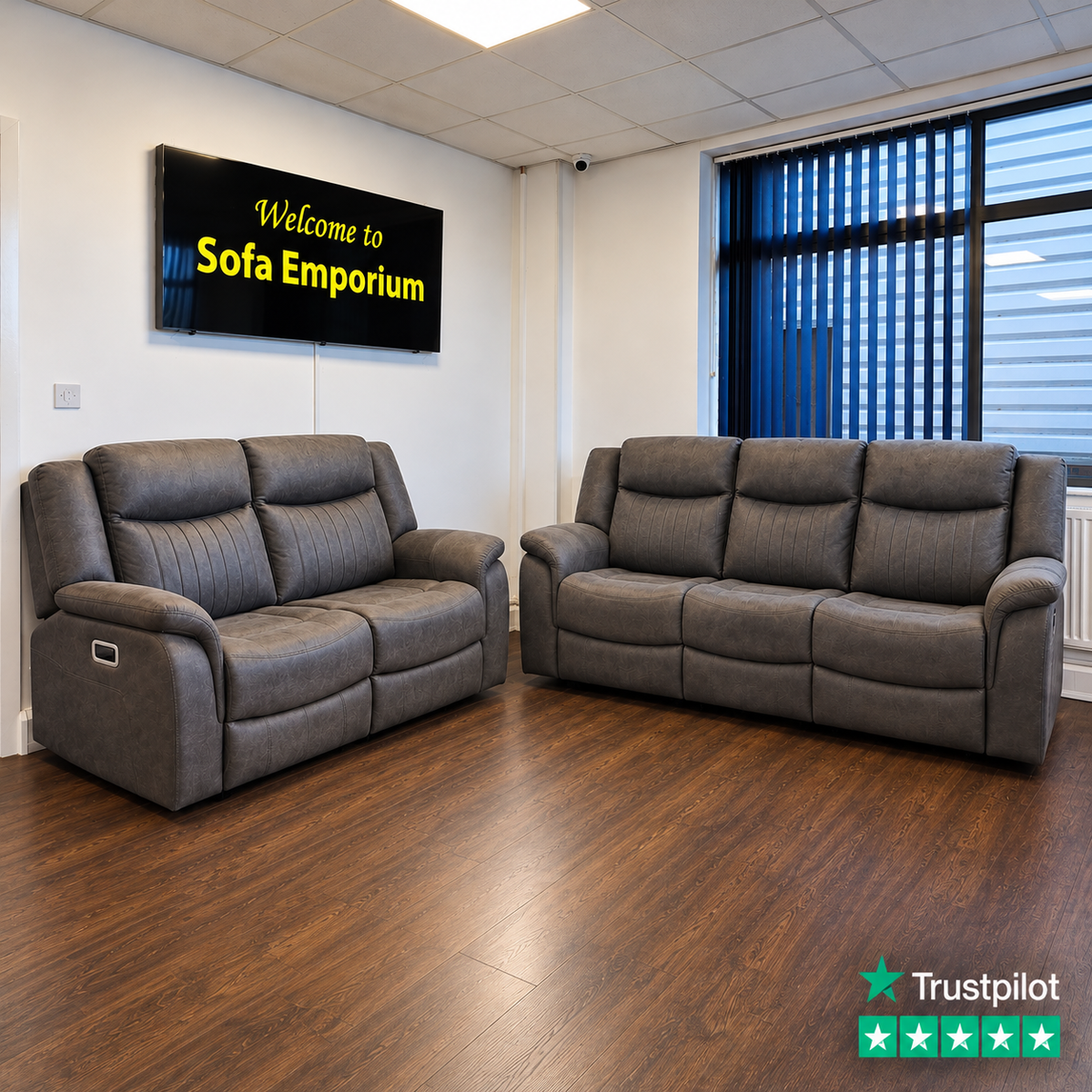 Darlington fabric reclining 3-seater and 2-seater sofas featuring padded armrests, vertical stitched backrests and electric recliner controls, displayed in the Sofa Emporium showroom.