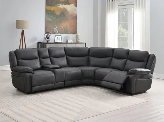 Black leather sectional sofa in a living room setting with a painting and lamp in the background.